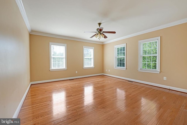 spare room featuring ceiling fan, baseboards, light wood-style floors, and ornamental molding