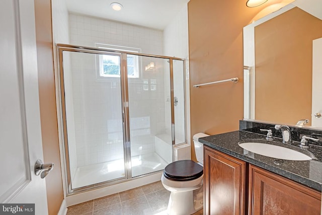 bathroom with tile patterned flooring, a shower stall, toilet, and vanity