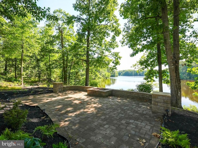 view of property's community with a patio area and a water view