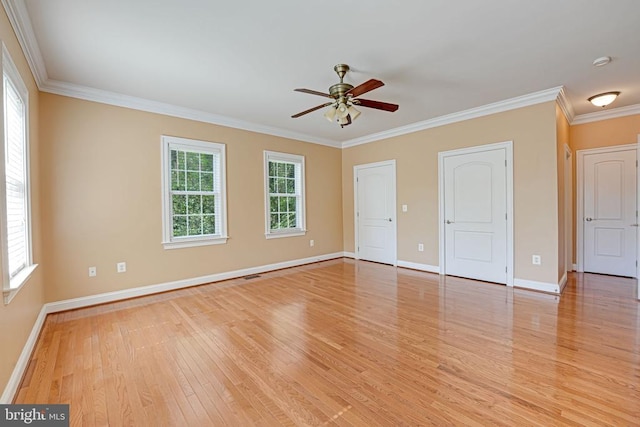 unfurnished bedroom with crown molding, light wood-style flooring, and multiple windows