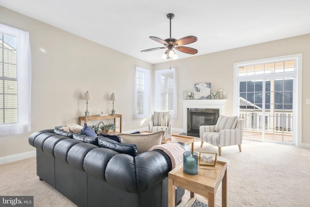 carpeted living room featuring plenty of natural light and ceiling fan