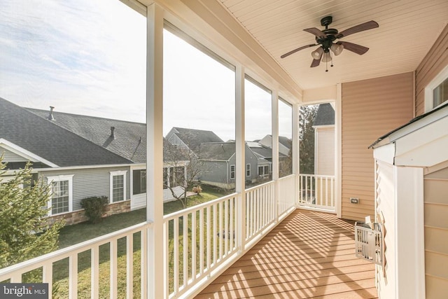 unfurnished sunroom featuring ceiling fan