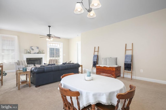 dining room with light carpet and ceiling fan