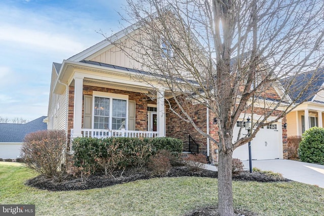 view of front of property with a garage, covered porch, and a front lawn