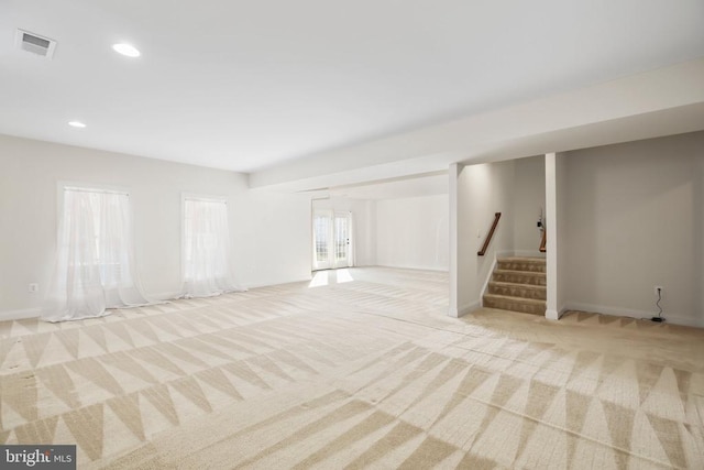 basement featuring light colored carpet