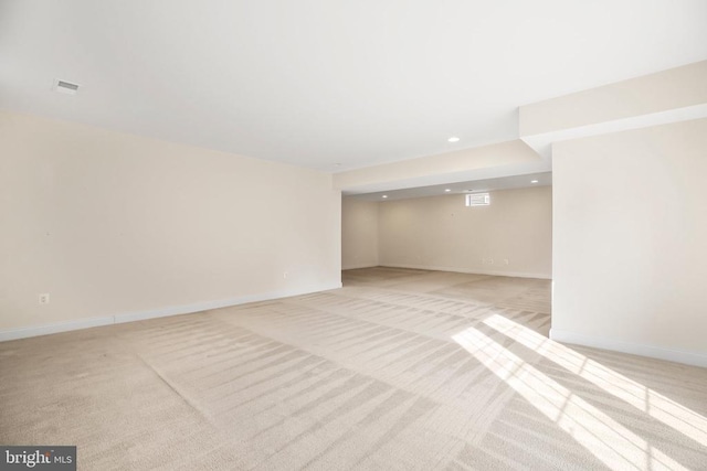 basement featuring light colored carpet