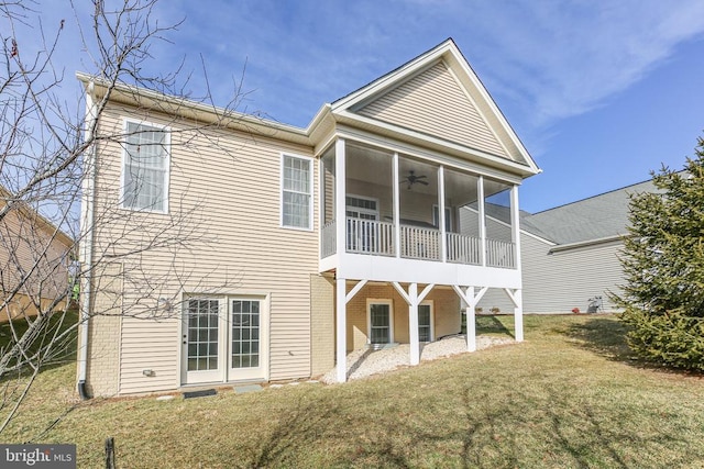 back of house with a yard, a sunroom, and ceiling fan