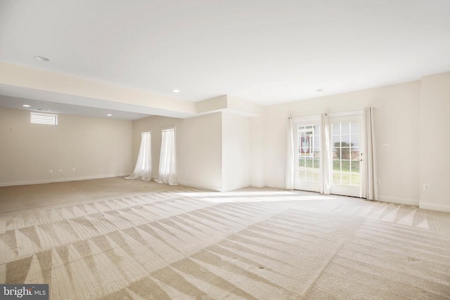 unfurnished room with light carpet