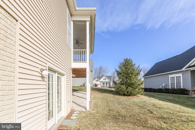 view of yard with french doors and ceiling fan