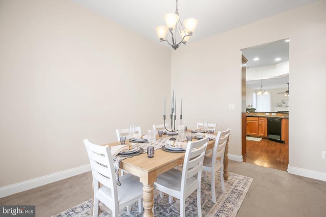 carpeted dining area featuring an inviting chandelier