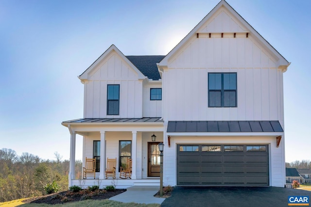 modern inspired farmhouse with a porch and a garage