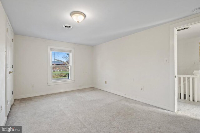 unfurnished room with light colored carpet