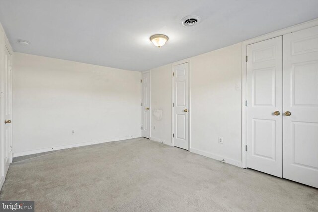 unfurnished bedroom featuring light colored carpet