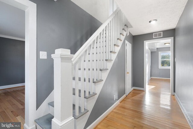 stairs with hardwood / wood-style flooring