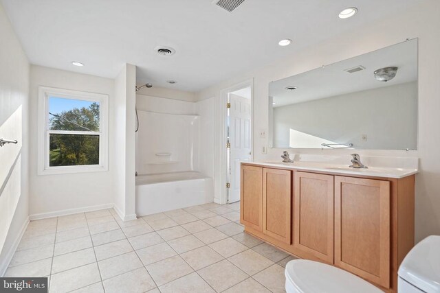 bathroom featuring tile patterned floors, toilet, vanity, and a shower