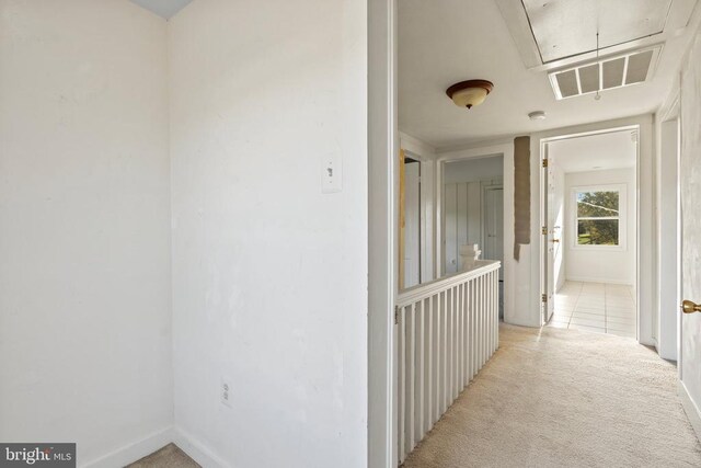 hallway with light colored carpet