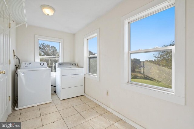 laundry room featuring light tile patterned floors and washer and clothes dryer