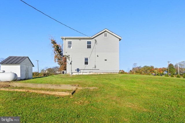 rear view of property with a yard