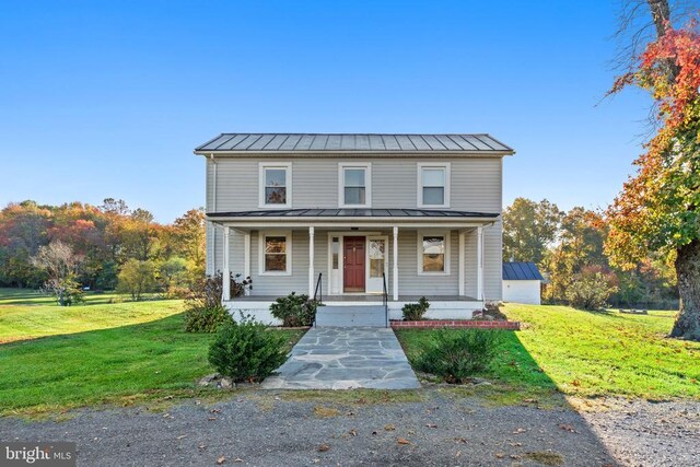 view of front property with a porch and a front yard