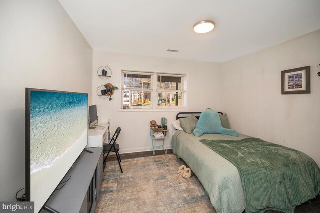 bedroom with visible vents and baseboards