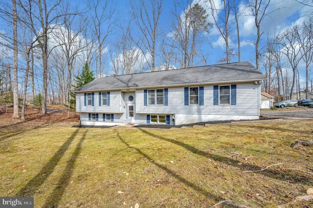 split foyer home with a front lawn and entry steps