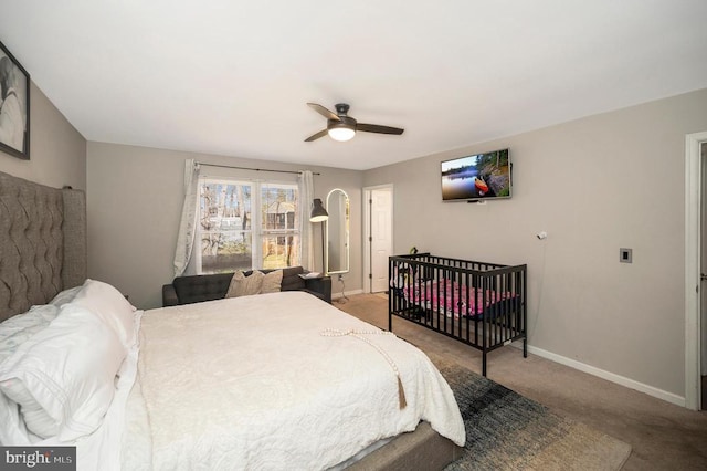 carpeted bedroom featuring a ceiling fan and baseboards