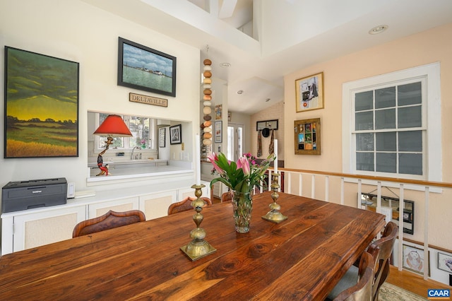 dining space featuring vaulted ceiling and recessed lighting