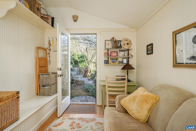 doorway to outside with vaulted ceiling and wood finished floors