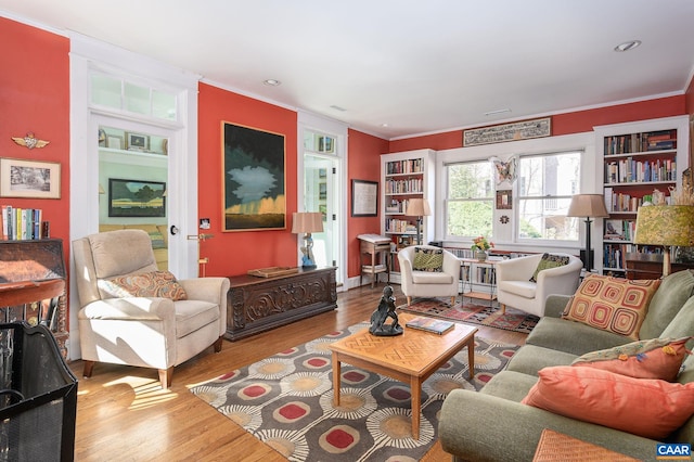 living room featuring ornamental molding and wood finished floors