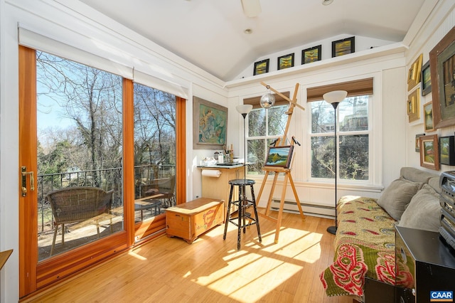 sunroom / solarium featuring vaulted ceiling, baseboard heating, and a ceiling fan