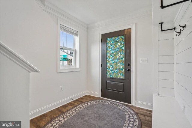 entrance foyer with ornamental molding and dark hardwood / wood-style flooring