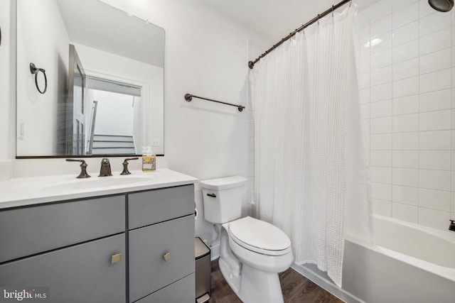 full bathroom featuring hardwood / wood-style flooring, vanity, toilet, and shower / bath combo with shower curtain