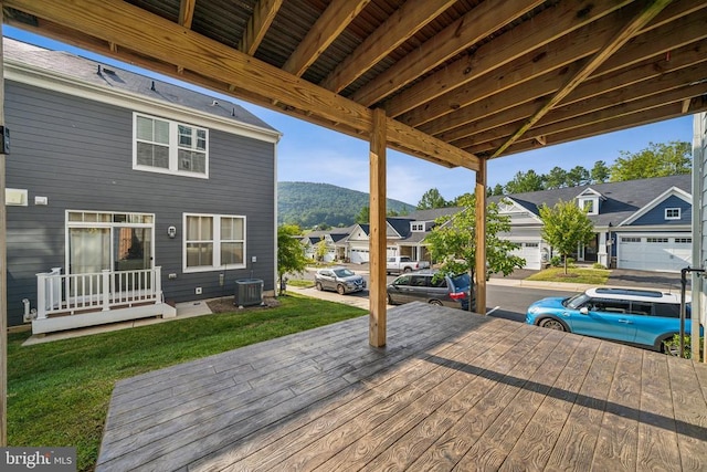 wooden deck with a mountain view and central air condition unit