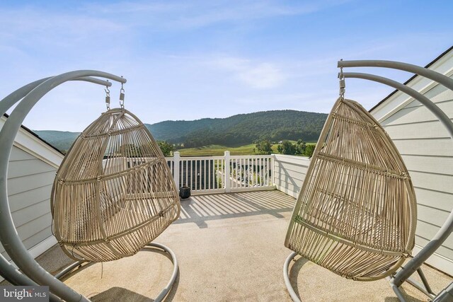 view of patio with a balcony and a mountain view