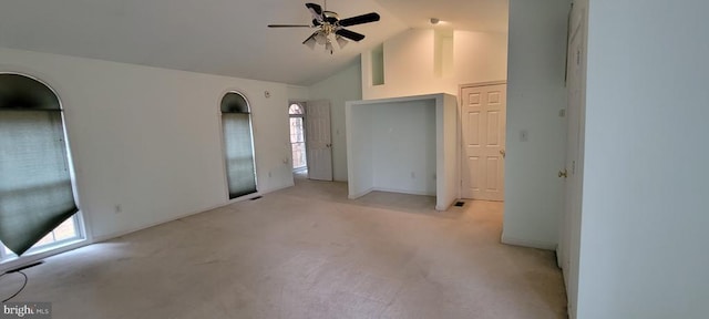 unfurnished bedroom with light colored carpet and high vaulted ceiling