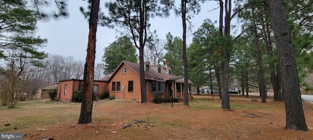 view of side of property featuring brick siding