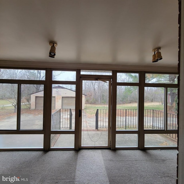 unfurnished sunroom featuring a water view