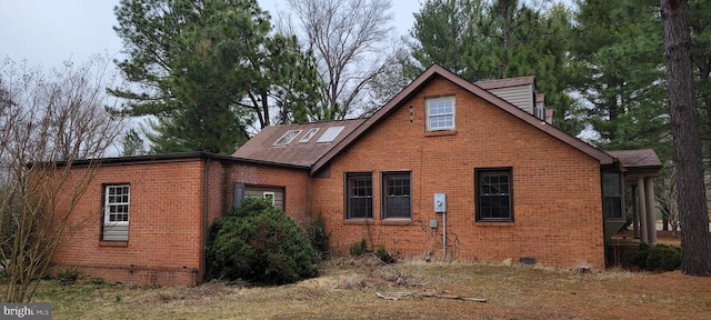 view of side of home featuring brick siding