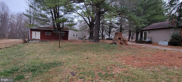 view of yard with an outbuilding and fence