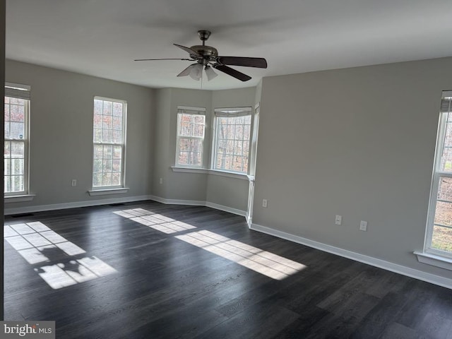 unfurnished room with dark wood-type flooring and ceiling fan