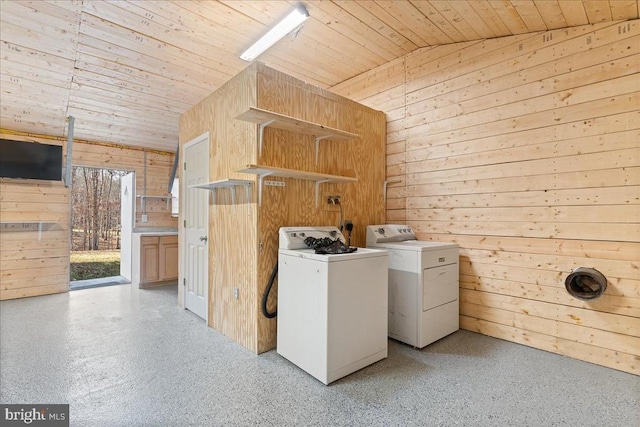 washroom featuring independent washer and dryer, wooden ceiling, laundry area, and wood walls