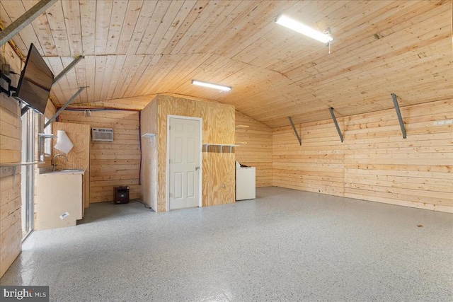 interior space with a sink, wooden walls, wooden ceiling, speckled floor, and lofted ceiling