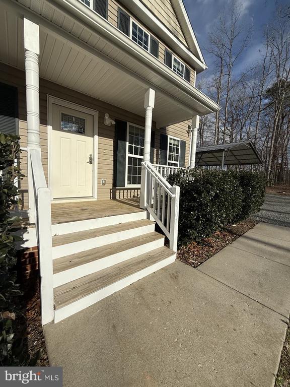 view of exterior entry with a porch