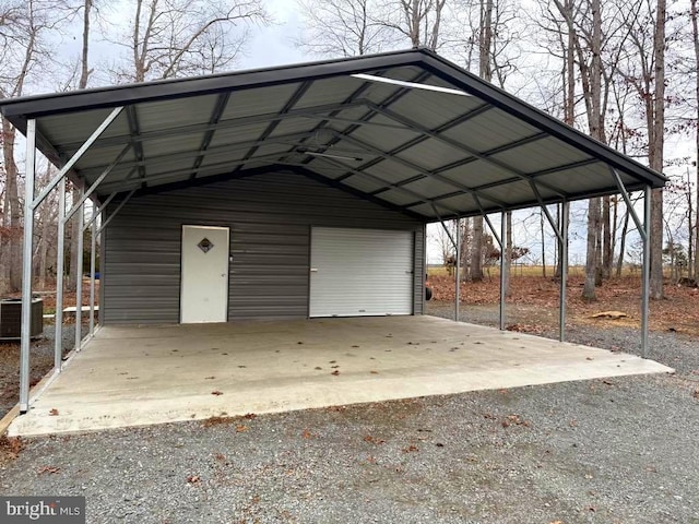 exterior space with a garage, a carport, and central AC unit