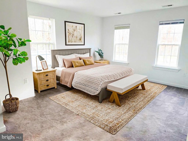 bedroom with visible vents, baseboards, and carpet flooring