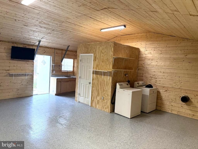 laundry room with wooden walls, wooden ceiling, and washing machine and clothes dryer