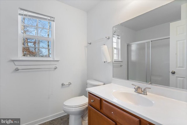 full bathroom with a wealth of natural light, a shower stall, vanity, and toilet