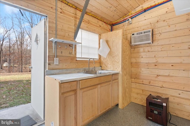 kitchen featuring a sink, wooden walls, wood ceiling, and a wall unit AC