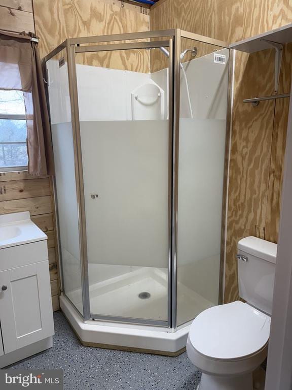 full bathroom with speckled floor, toilet, visible vents, and a stall shower