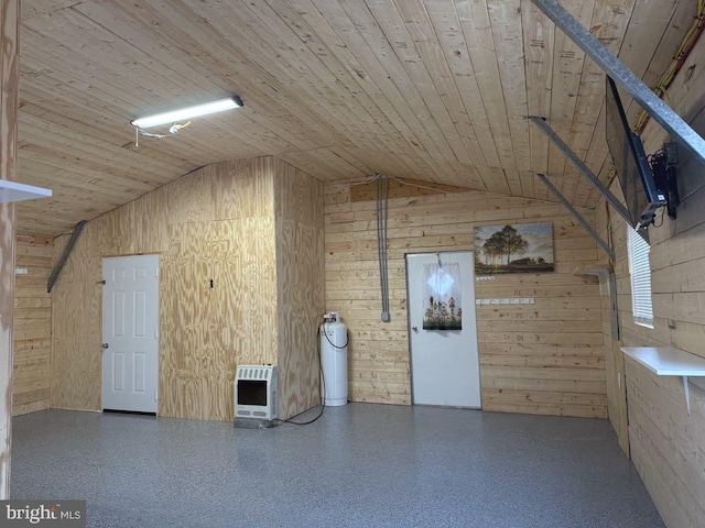 interior space with wooden walls, vaulted ceiling, wooden ceiling, heating unit, and speckled floor